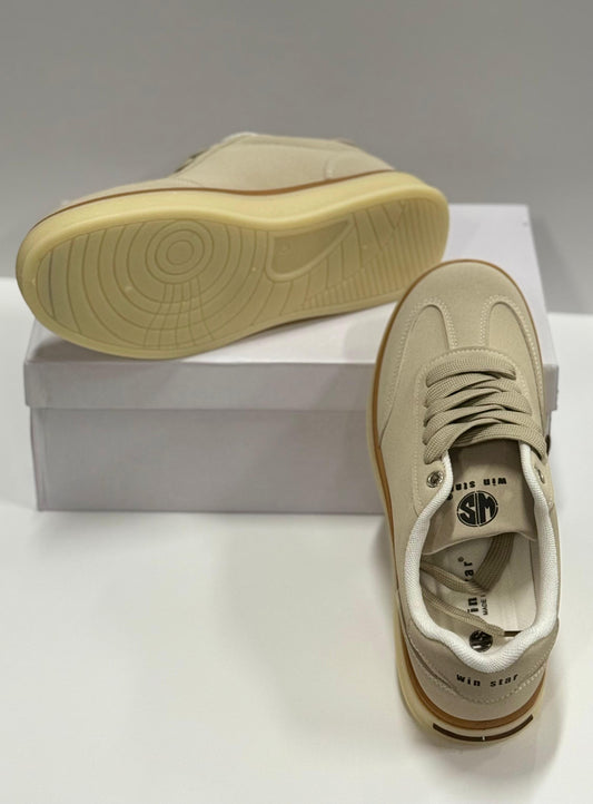 Beige sneakers with a white box on a light gray background