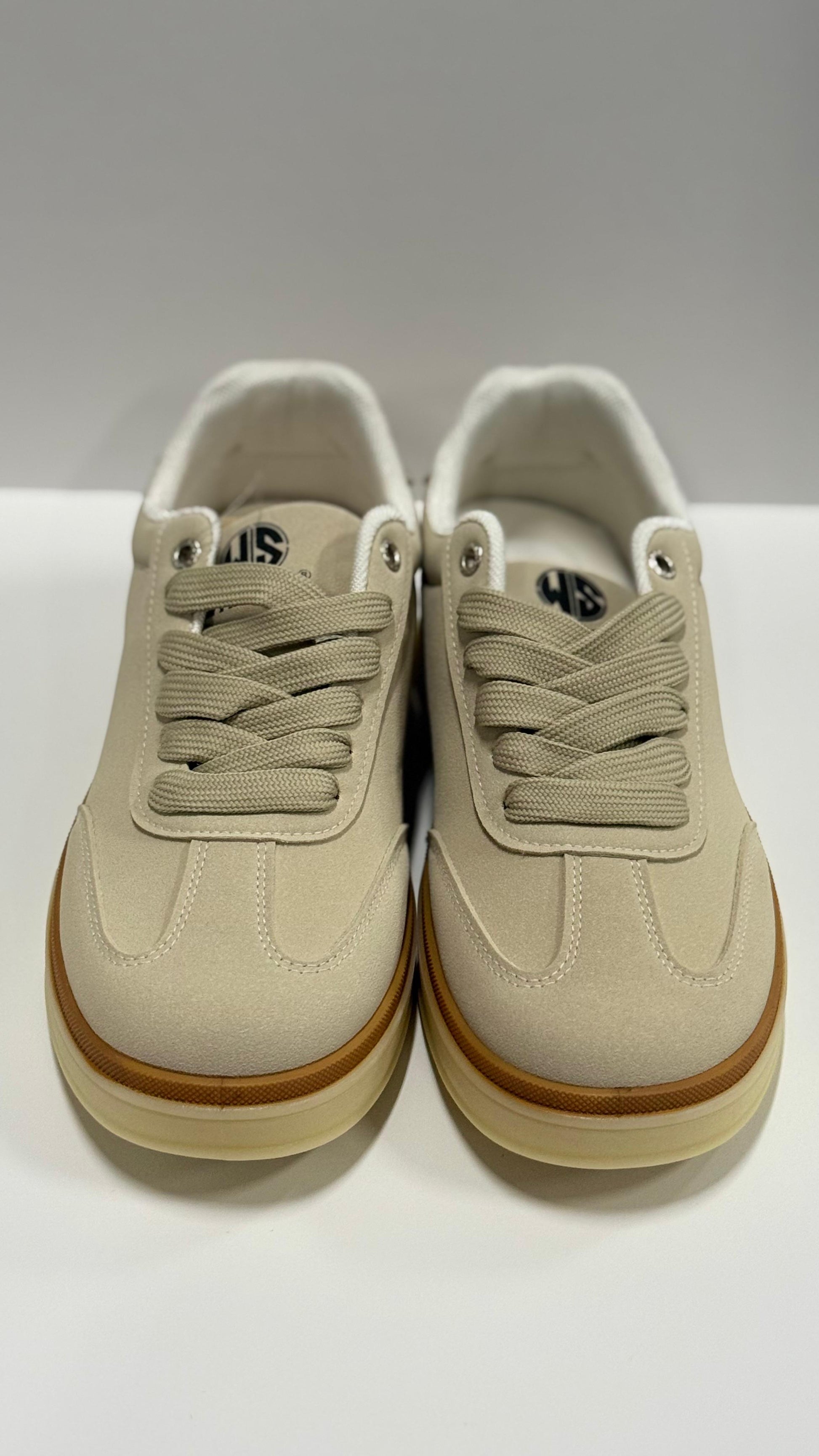 Beige sneakers with brown soles on a white background