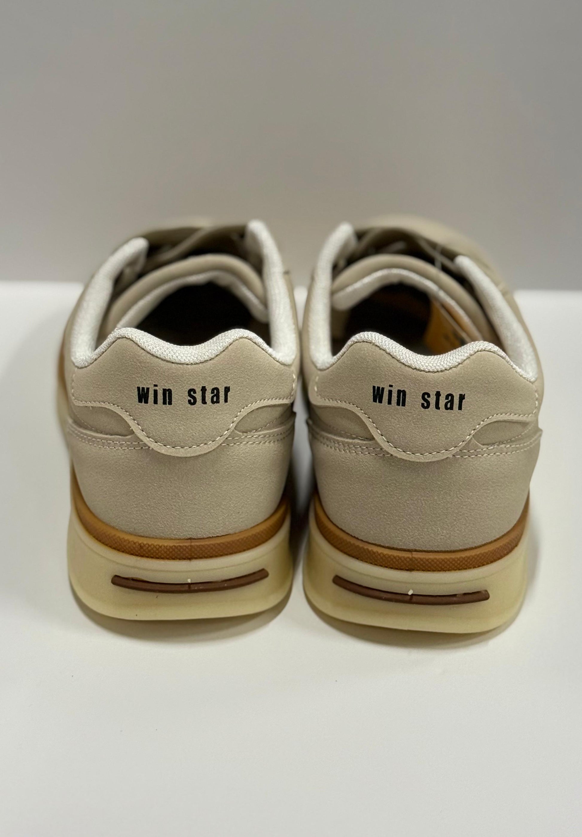 Pair of beige sneakers with 'win star' branding on a white background